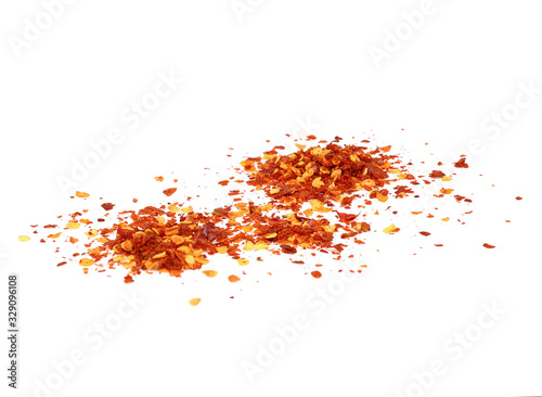 dried chili flakes and seeds isolated on white background, top view © pairoj