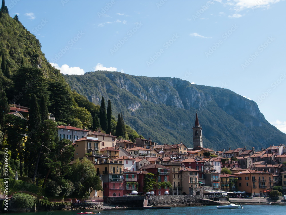 panoramic view of mountains and Varenna city from ferry, Como lake, Lombardy, Italy