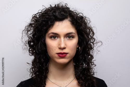 Head and shoulders horizontal portrait of attractive brunette latin girl