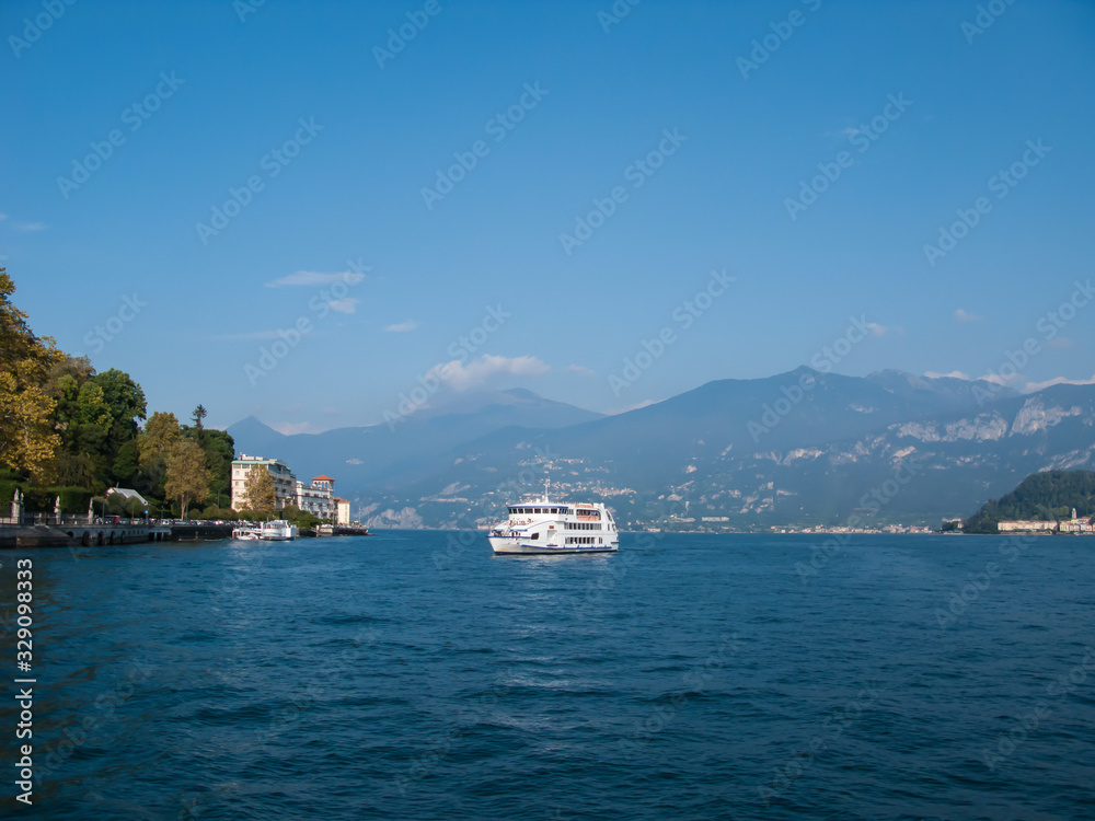 panoramic view of lake como and mountains on a sunny day