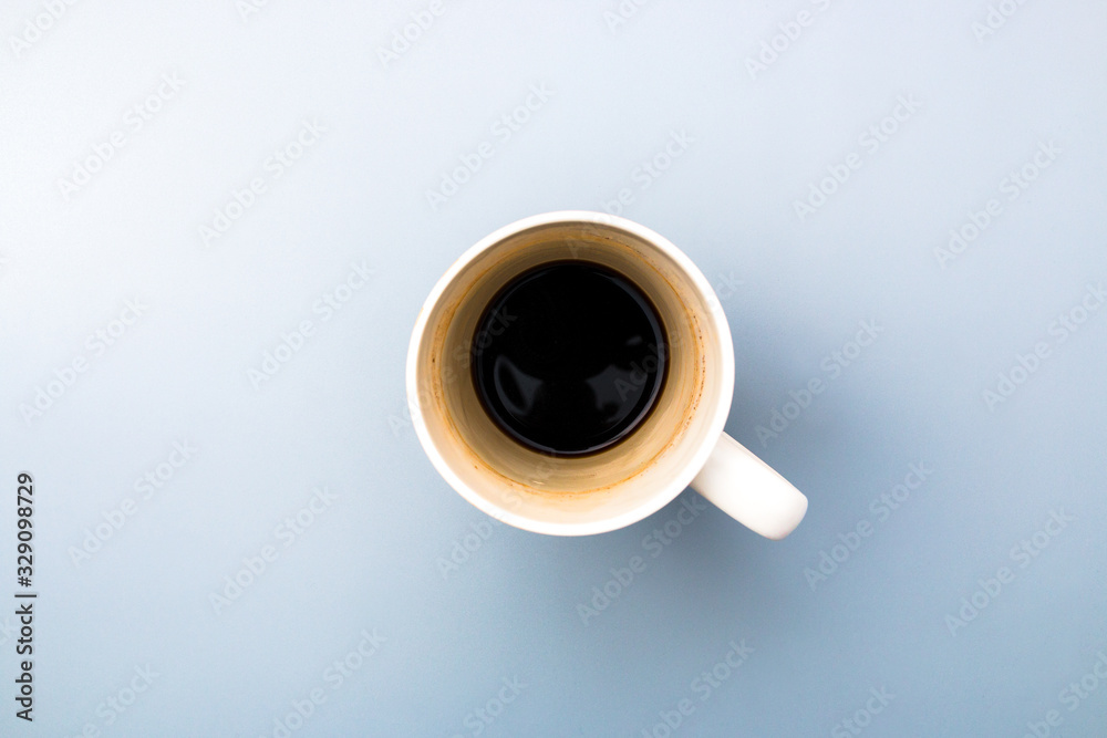 top view of an empty white coffee mug on grey background top view of an empty white coffee mug on grey background