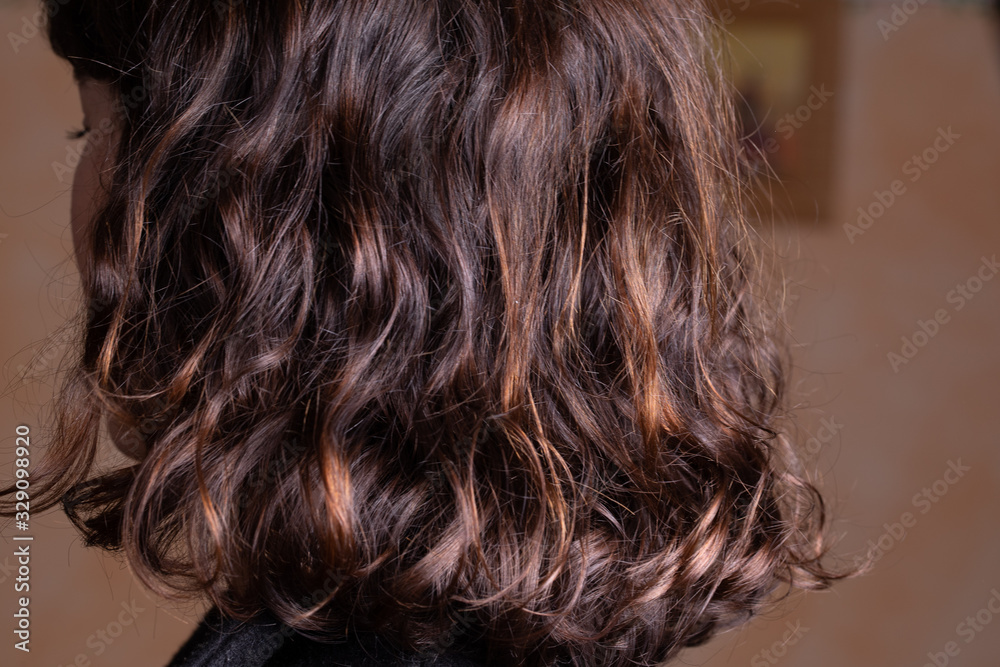 Medium length clean shiny hair with natural waves. Blurred background with some copy space Medium length clean shiny hair with natural waves. Blurred background with some copy space