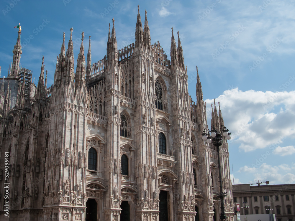 Duomo di Milano on background of blue sky at sunny day, Milan, Lombardy, Italy