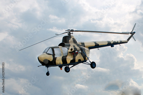 Fototapeta Naklejka Na Ścianę i Meble -  helicopter against a cloudy sky