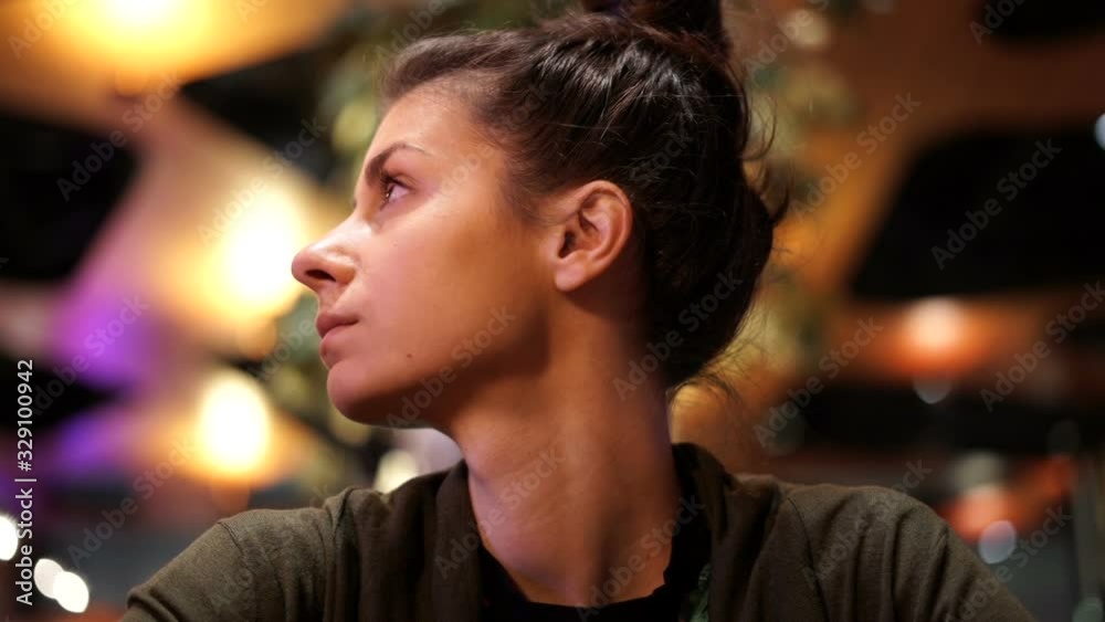 Woman impatiently waiting for ordered food in a restaurant, looking around Woman impatiently waiting for ordered food in a restaurant, looking around