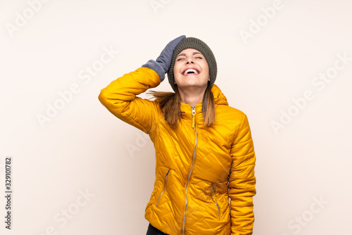 Woman with winter hat over isolated background laughing © luismolinero