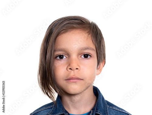 serious little boy on white background