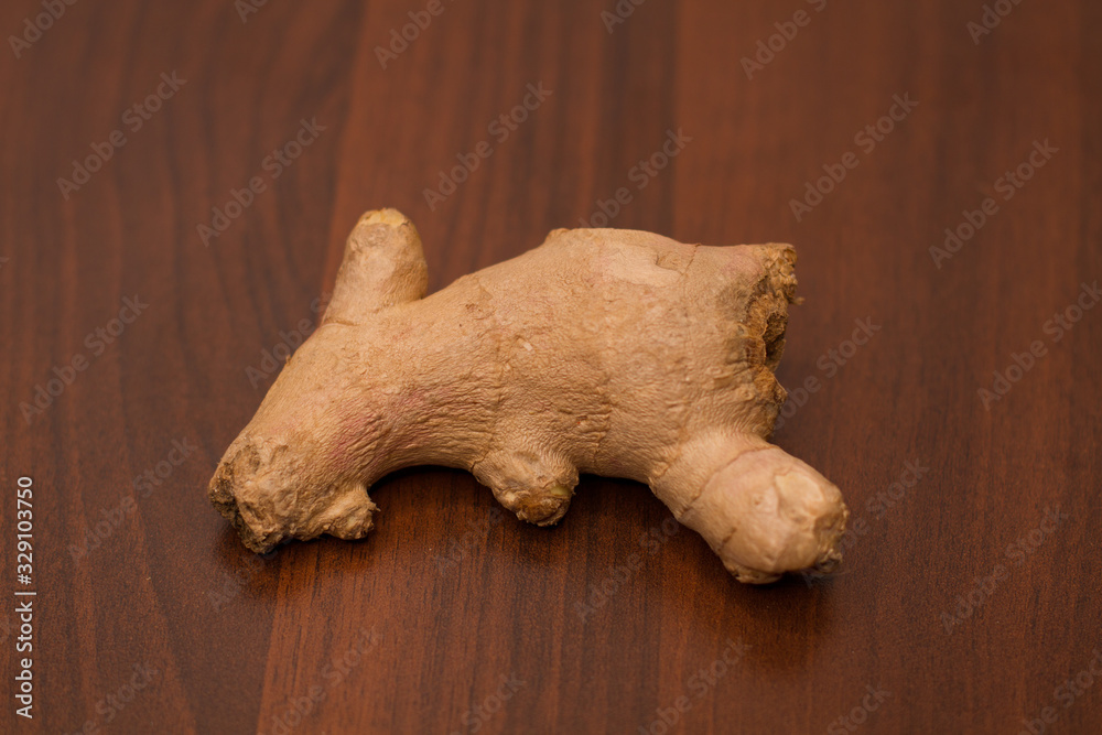 Ginger root isolated on a wooden background Ginger root isolated on a wooden background