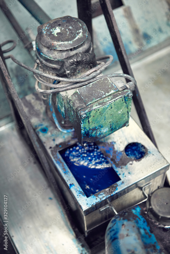 An industrial paint and colour mixing machine mixing paint in an industrial machine. paint