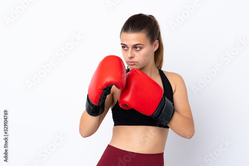 Teenager sport girl over isolated white background with boxing gloves © luismolinero
