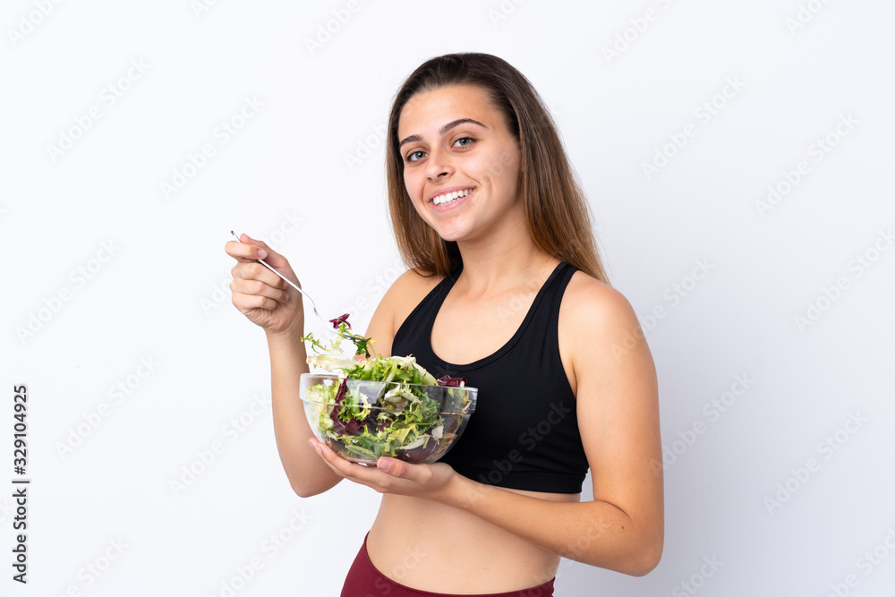 Teenager girl with salad over isolated background Teenager girl with salad over isolated background