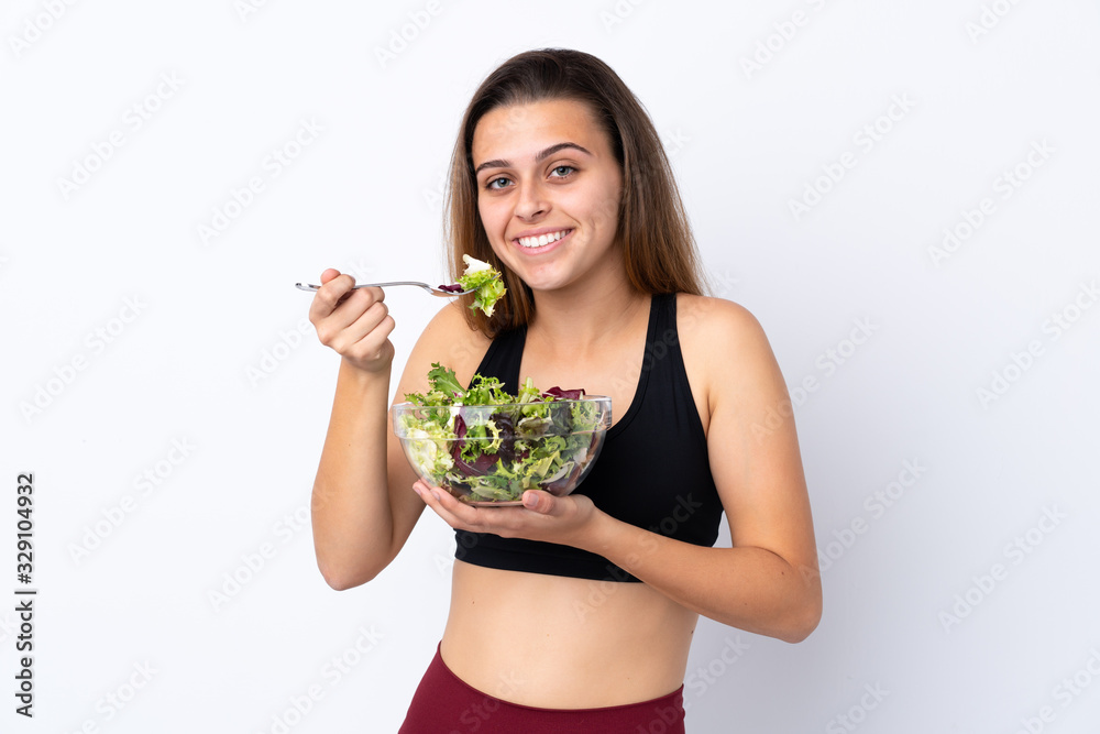 Teenager girl with salad over isolated background Teenager girl with salad over isolated background