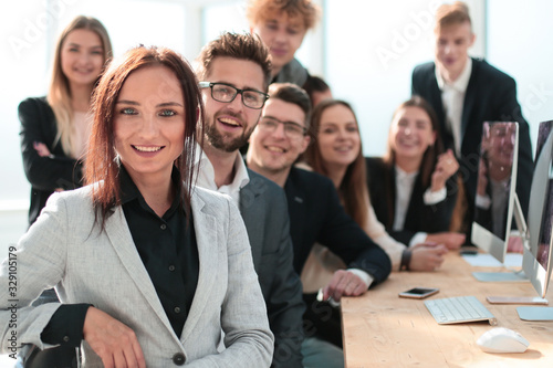 young businesswoman sitting in front of her business team.