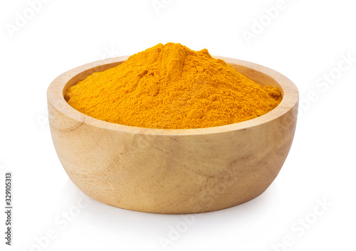 turmeric powder in wood bowl on white background photo