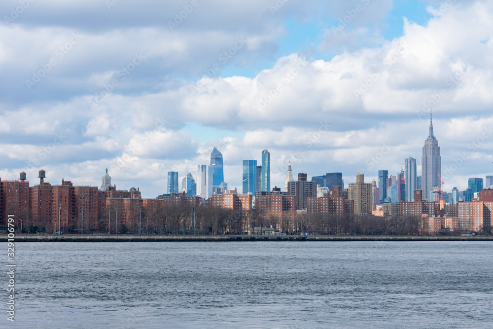 Midtown Manhattan Skyline with Clouds along the East River in New York City