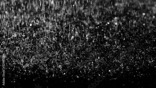 Droplets of rain falling on the surface on an isolated background
