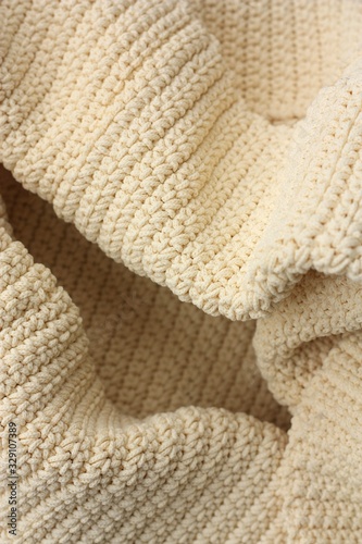Beautiful beige knitted fabric close up view 