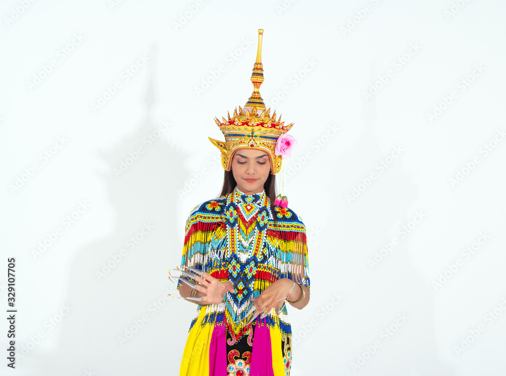 Fototapeta premium The beautiful woman wearing Thai Tradition southern costume and put headdress on her head,standing on white background,folk dance,black shadow reflection on white background
