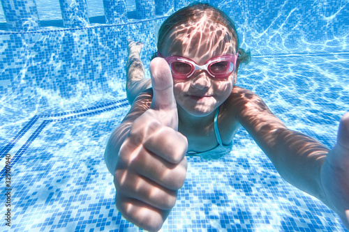 Pretty little girl in swimming pool , summer vacations.