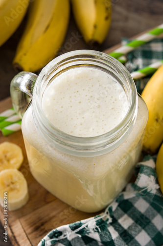Banana smoothie in jar on wooden table	