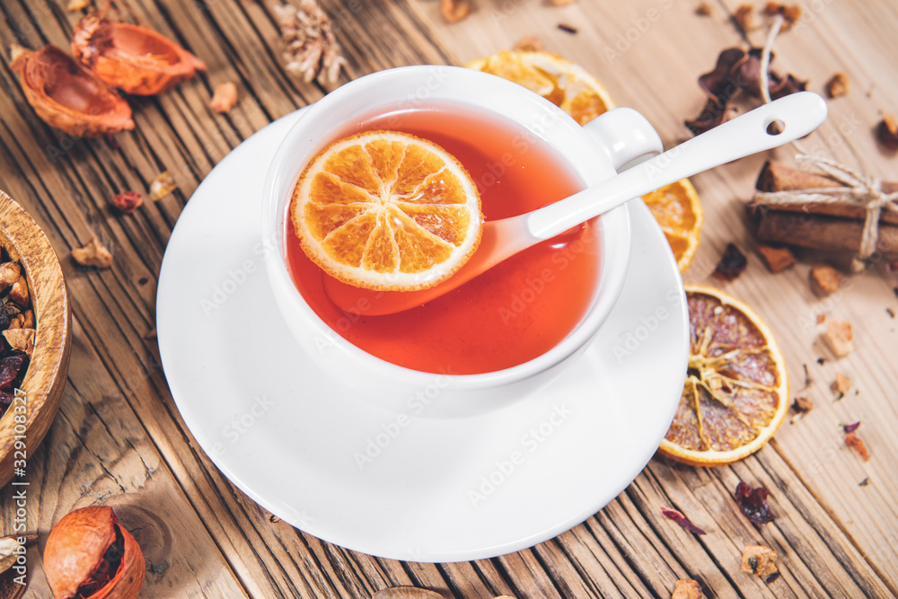 Fruit tea cup with cinnamon dried orange and berries Fruit tea cup with cinnamon dried orange and berries