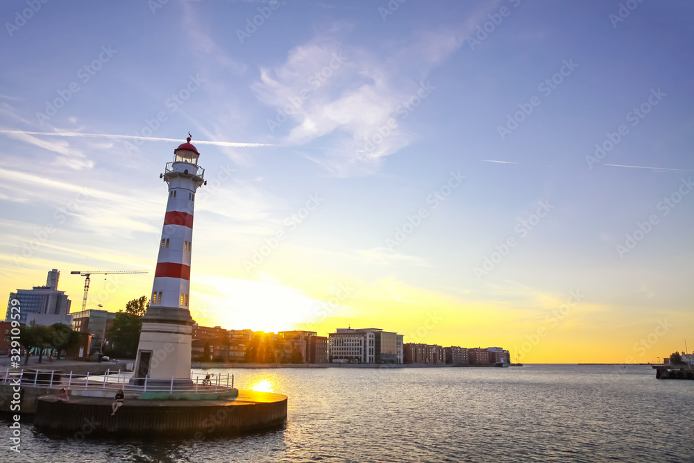 Old lighthouse (built in 1878) in Oresund strait, Malmo city harbor, Sweden. Octagonal lighthouse at the entrance to the inner harbor of Malmo