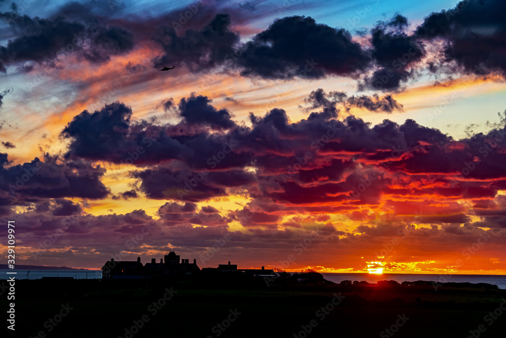 Cloudy Sunset of Rest Bay Rooftops