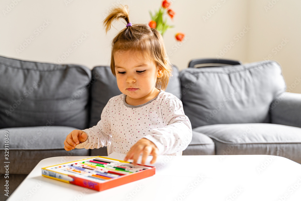 Small girl drawing with felt tip pen at home Small girl drawing with felt tip pen at home