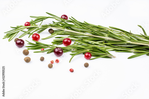 Branches of rosemary, a mixture of allspice, cranberries isolated on a white background.