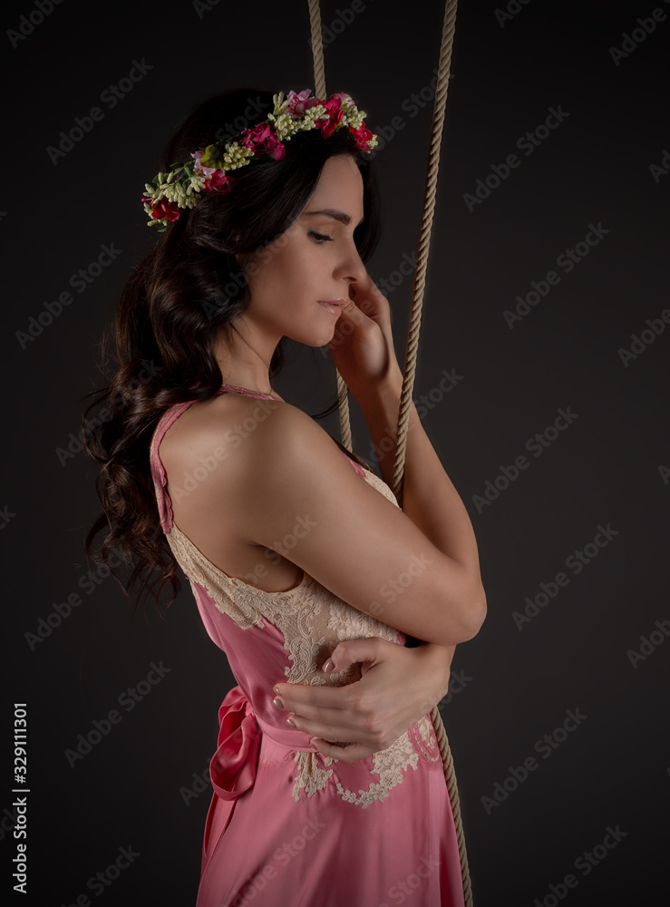 Fototapeta premium young girl on swing with romantic dress and renaissance atmosphere