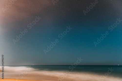 Goa, India. Real Night Sky Stars. Natural Starry Sky In Blue Color Above Indian Ocean Sea Seascape Beach Copast. Background