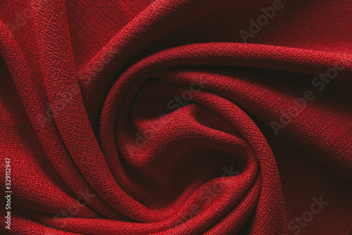 Jute red linen on a table in natural light, folded