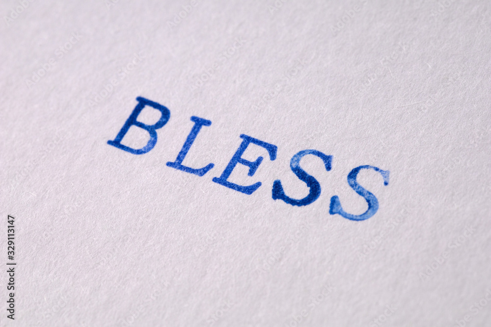 a bless word stamped on a piece of paper. a bless word stamped on a piece of paper.