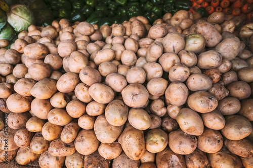 Organic Brown Potatoes On Local Agricultural Vegetable Market. Autumn Harvest Potatoes Background.