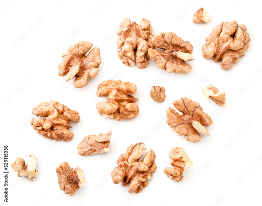 Peeled walnuts with slices on a white background. The view from top. Peeled walnuts with slices on a white background. The view from top.