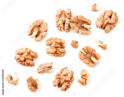 Peeled walnuts with slices on a white background. The view from top. photo