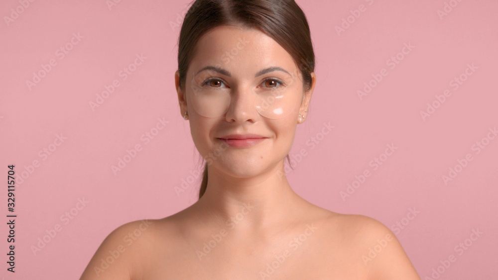 30s brunette woman wears an eye patches and smiling to the camera 30s brunette woman wears an eye patches and smiling to the camera