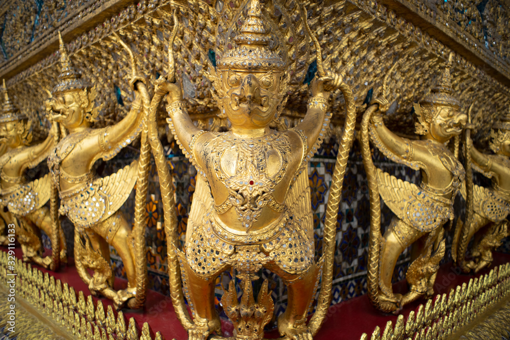 Golden Garuda Statues in the Wat Phra Kaeo Temple. This is the grand palace public temple and destination of Bangkok Thailand