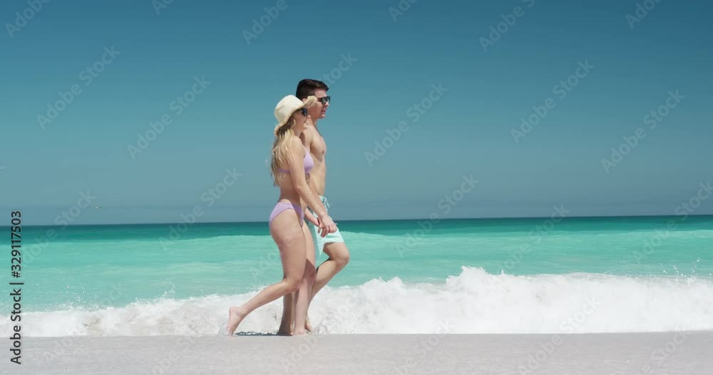 Couple in love enjoying free time on the beach together Couple in love enjoying free time on the beach together