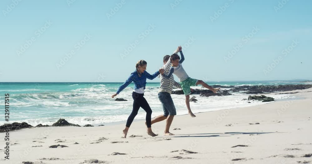 Couple and their son enjoying free time on the beach together Couple and their son enjoying free time on the beach together