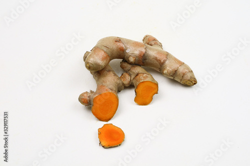 Fresh turmeric root isolated on a white background is an ingredient in turmeric foods and ingredients in skin care products. Turmeric helps the skin to be strong.