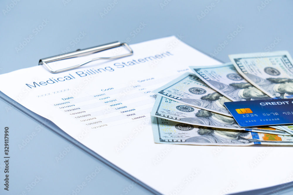 top view picture of medical billing statement, banknotes and credit card on the gray background top view picture of medical billing statement, banknotes and credit card on the gray background