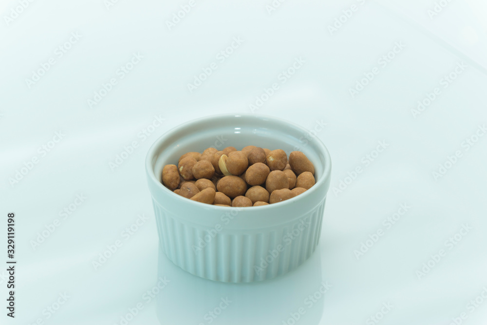 Roasted salty peanuts on white background with copy space. Roasted salty peanuts on white background with copy space.
