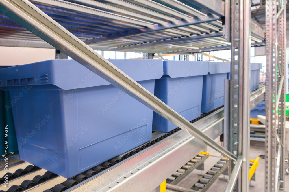 Automated storage warehouse with blue plastic crates Stock Photo