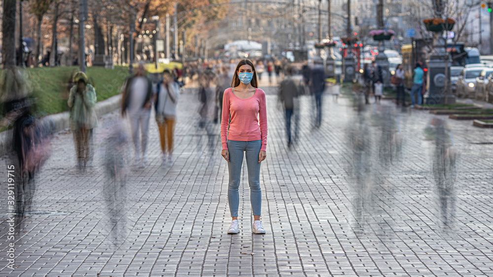 The woman with medical face mask stands on the crowded street - obrazy, fototapety, plakaty 
