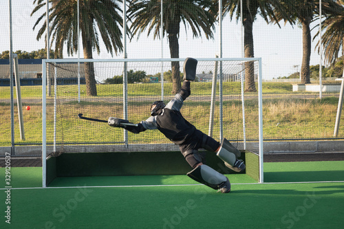 Front view of a Caucasian male field hockey goalkeeper photo