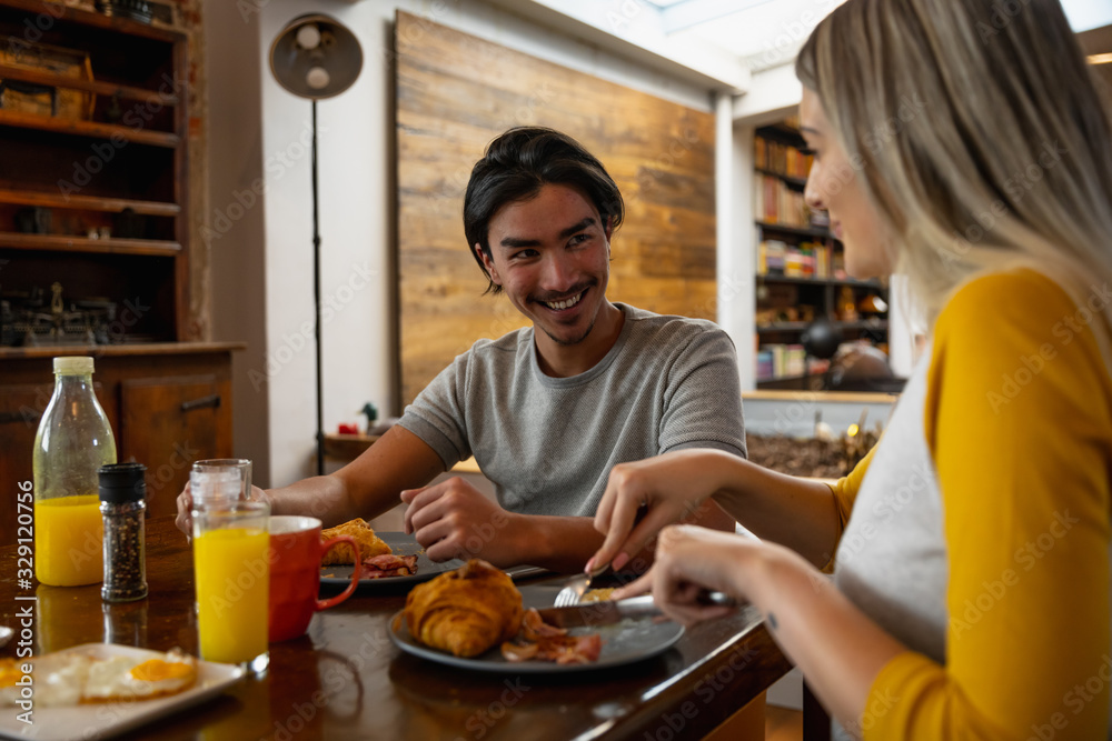 Young couple taking their breakfast together Young couple taking their breakfast together