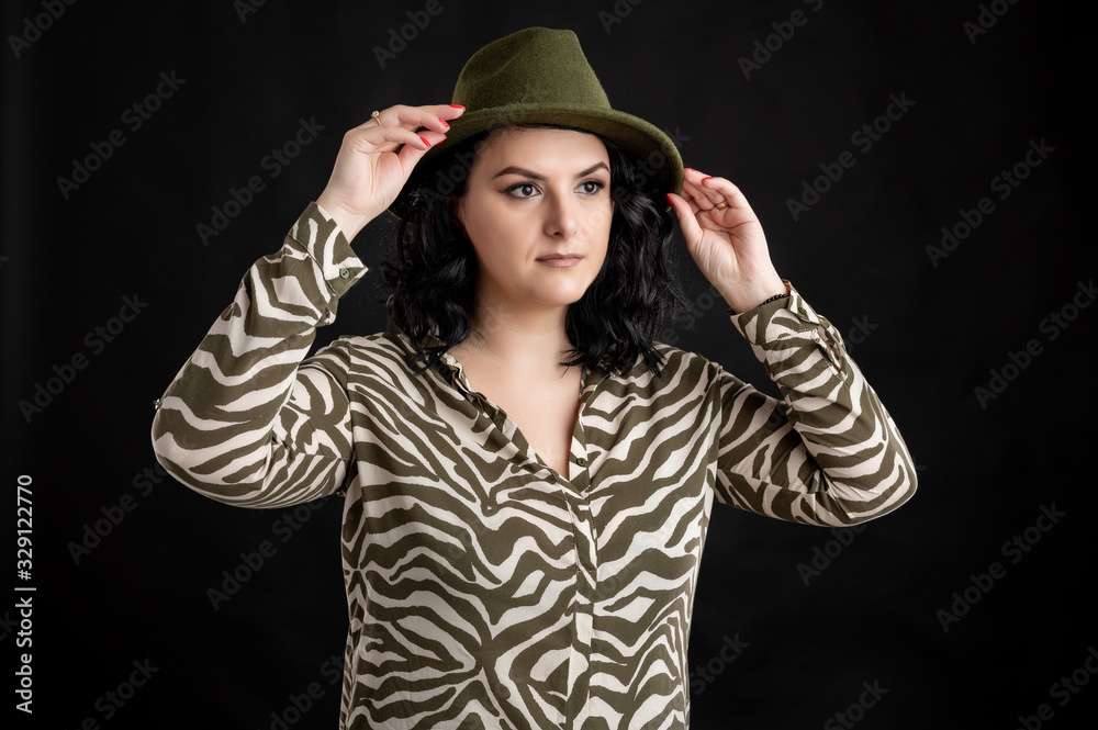 Attractive young woman dressed casually arrange her hat Attractive young woman dressed casually arrange her hat