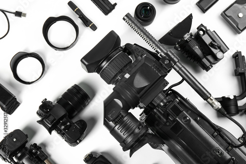 Flat lay composition with video camera and other equipment on white background
