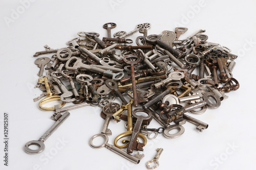 heap of different old keys on a white background